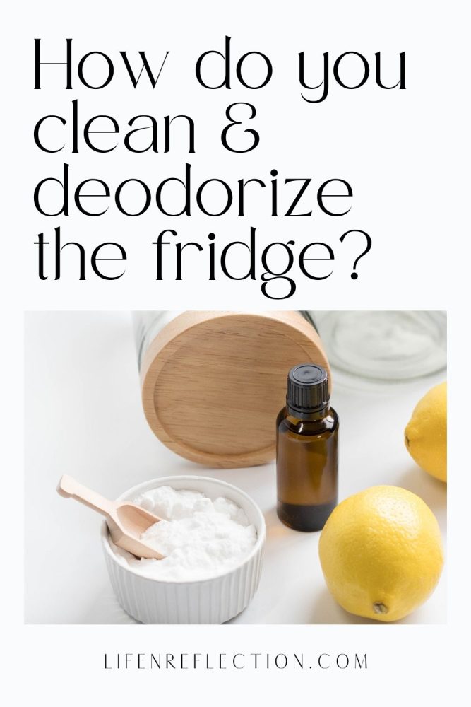 Close up of fresh yellow lemons, a dark bottle of essential oil and a white bowl of baking soda with wooden scoop with text that reads how do you clean and deodorize the fridge?