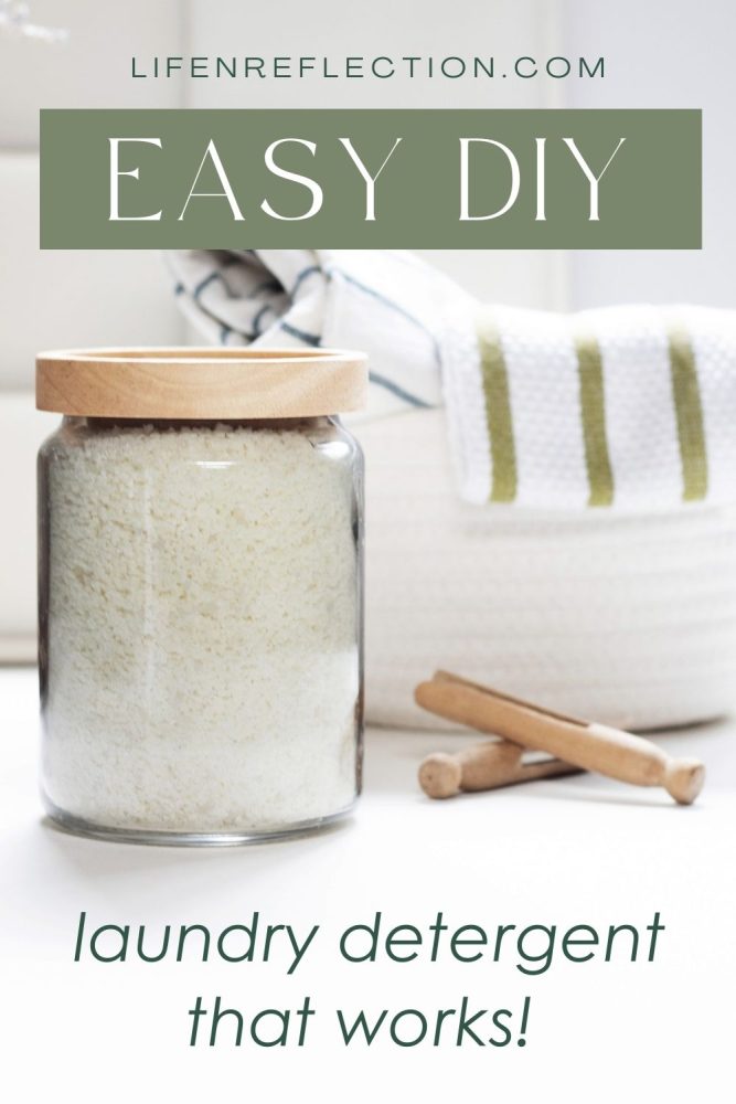 Jar filled with homemade laundry detergent next to wood clothespins.