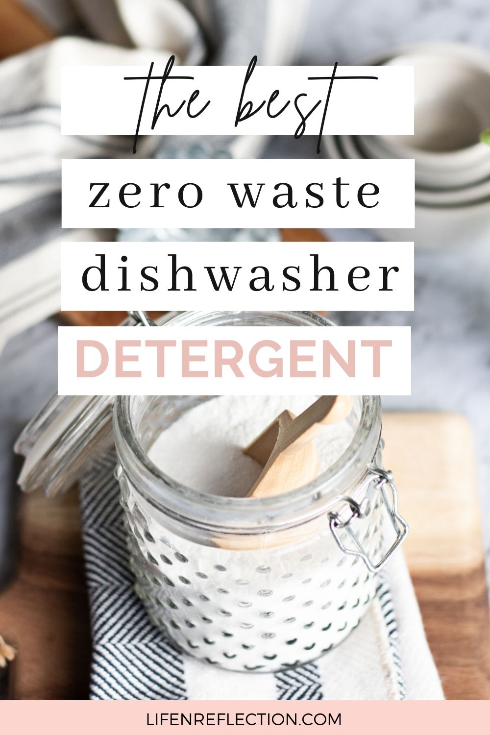 Open glass jar of homemade dishwasher detergent with a wooden scoop and text that reads the best zero waste dishwasher detergent