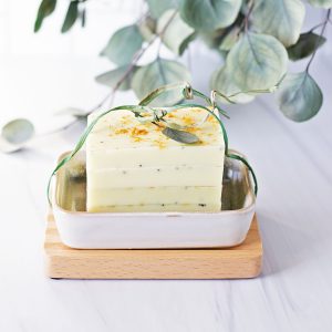stack of yellow lemon soap bars on light background