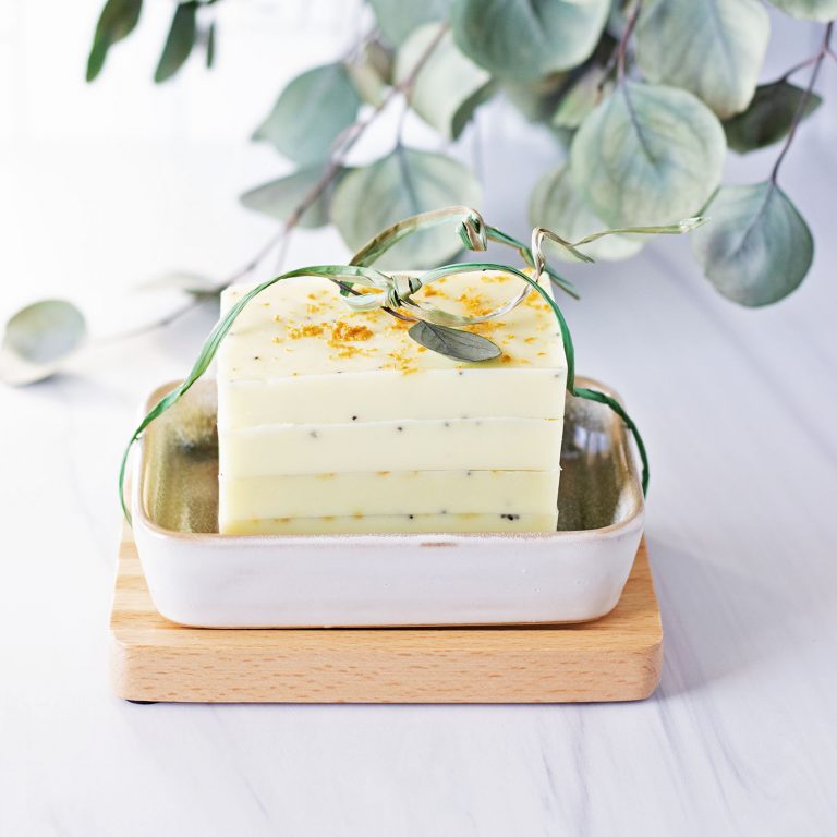 stack of yellow lemon soap bars on light background