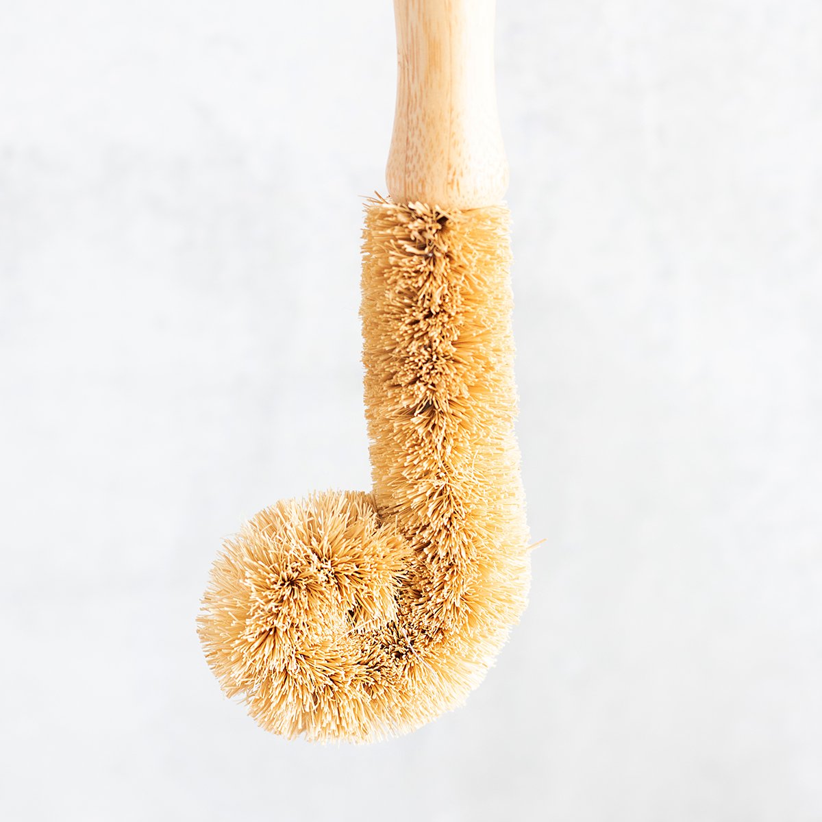 Closeup of a natural bristle dish brush wand.