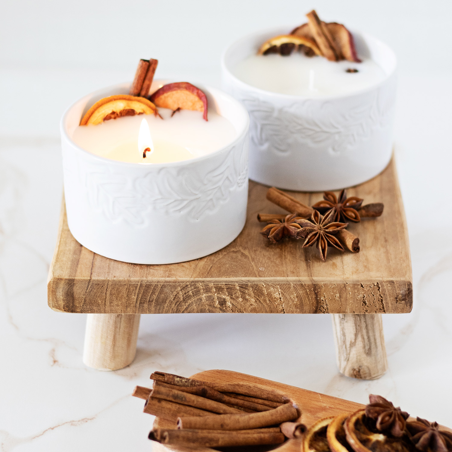 A handmade bowl candles surrounded by warm, autumn spices.