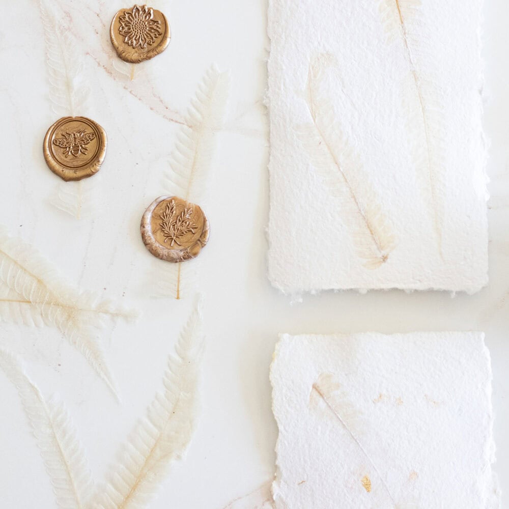 Learn how to make handmade paper with the dazzling allure of gold flakes and pressed leaves!