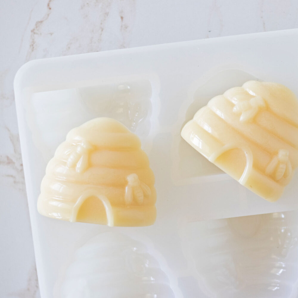 Handmade soaps just popped out of the soap mold laying on top.
