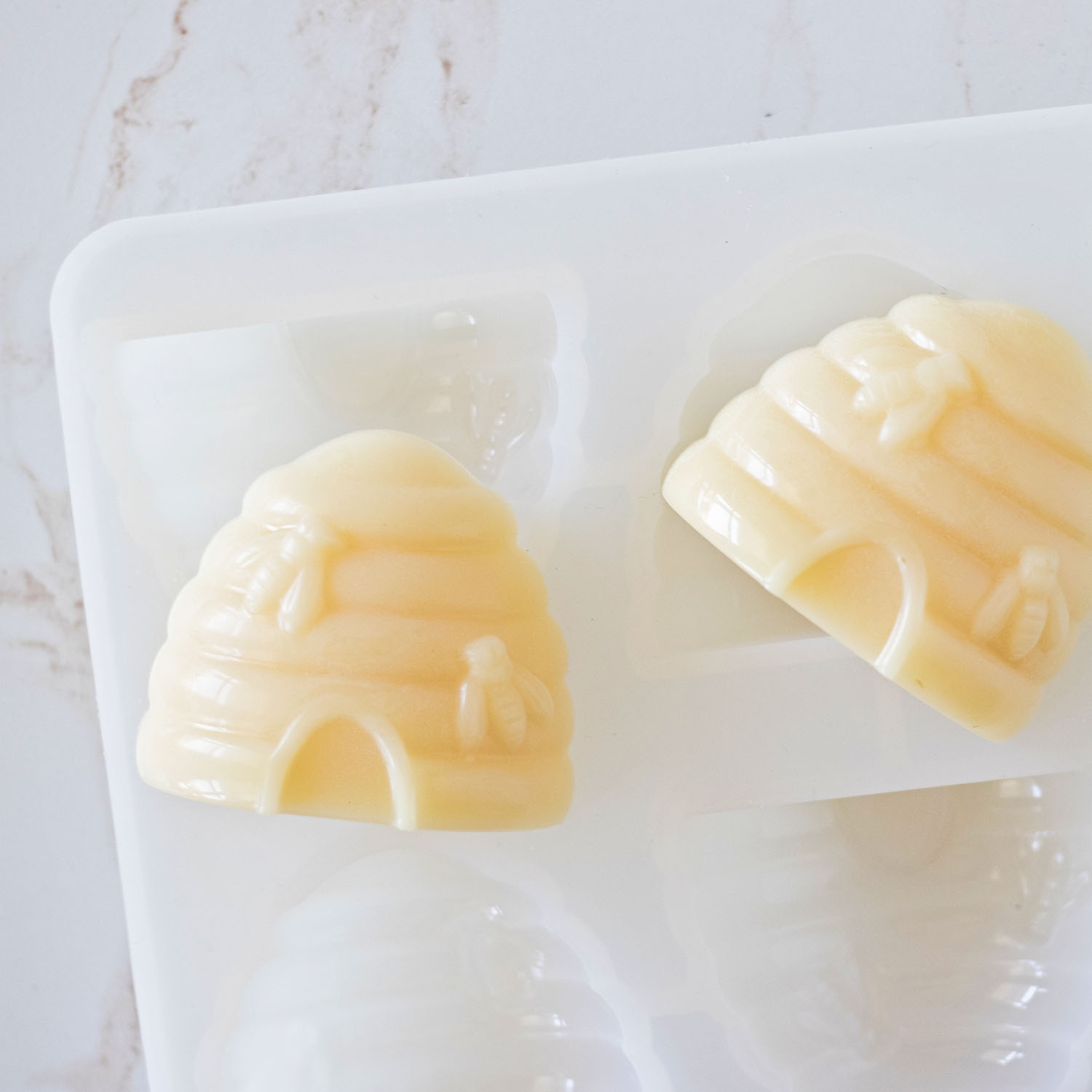Handmade soaps just popped out of the soap mold laying on top.