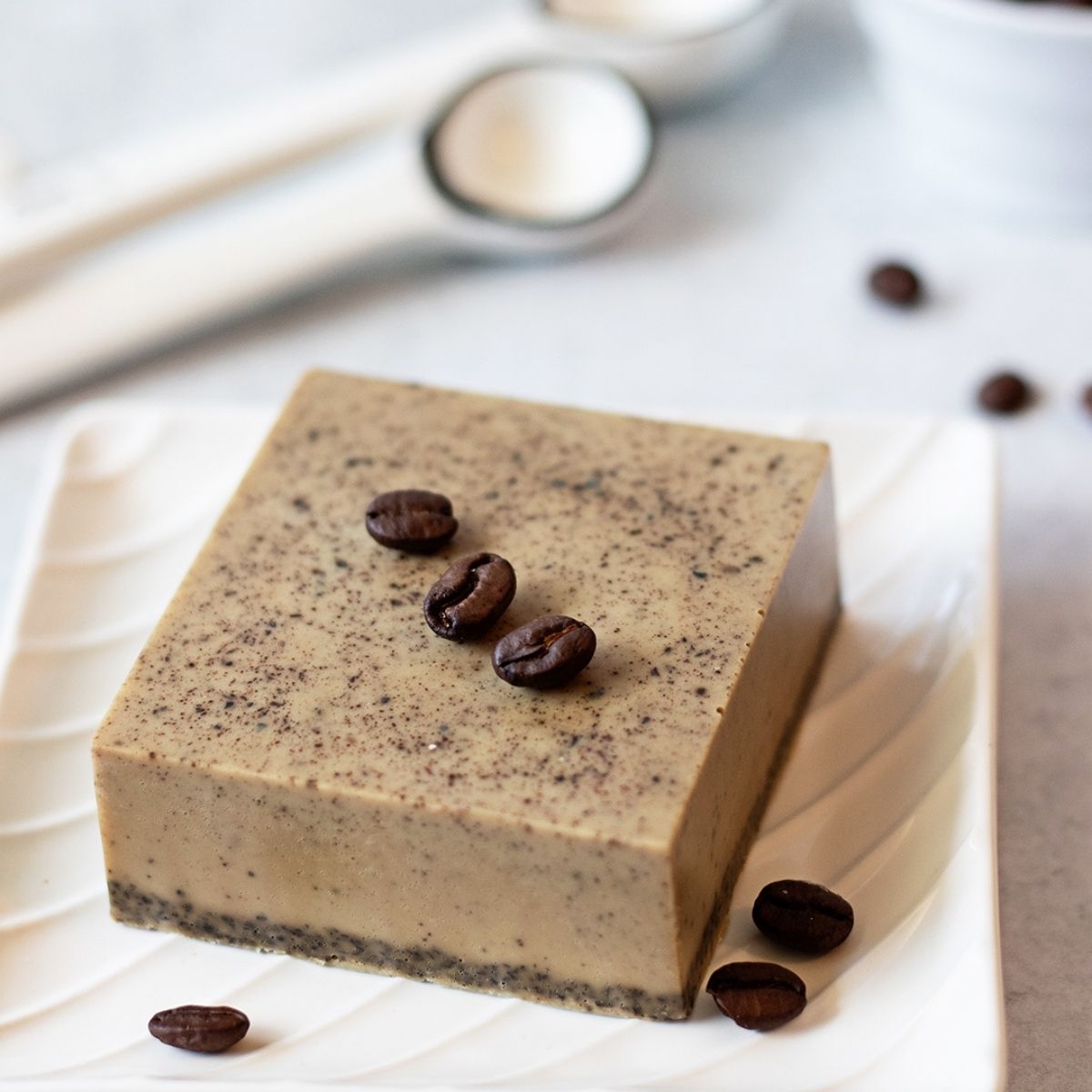 brown coffee soap bars textured with real coffee grounds on a white surface