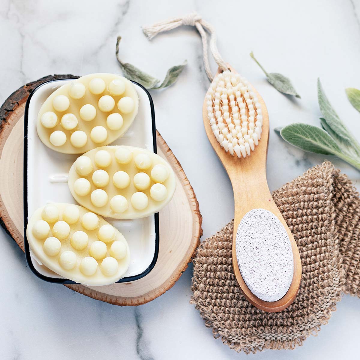 DIY massage bars on a tray with a body brush and sisal glove