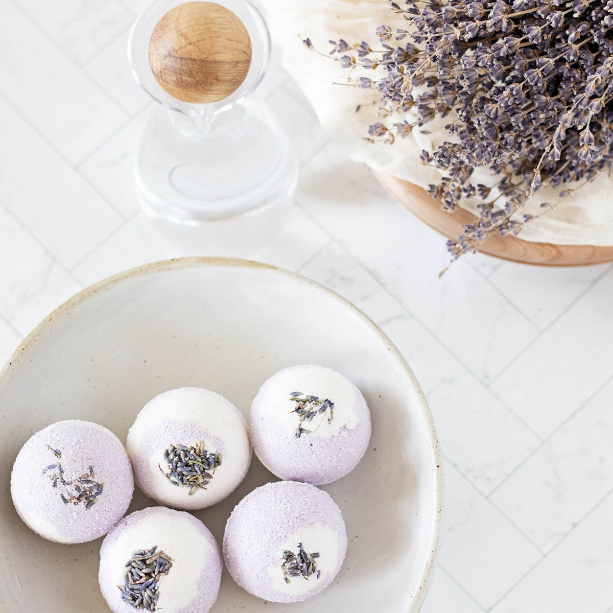 handmade marbled lavender and vanilla bath bombs in a ceramic bowl