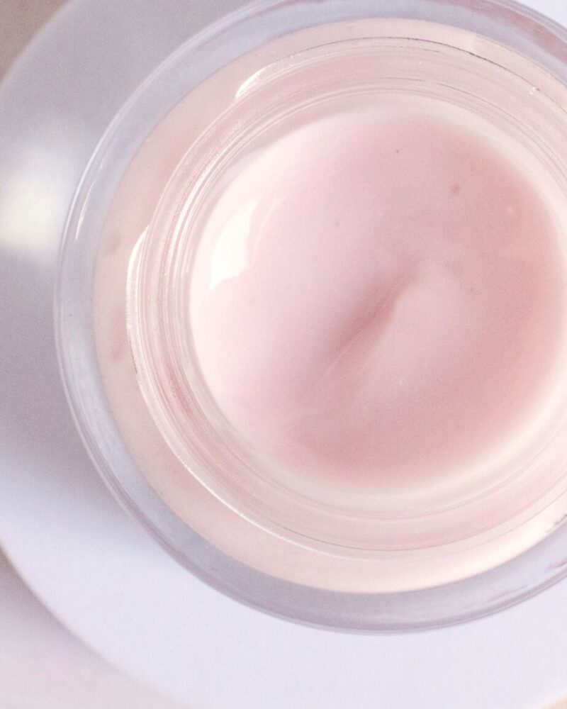 small jar of DIY water gelee cream in a soft pastel pink color with a slight shimmer