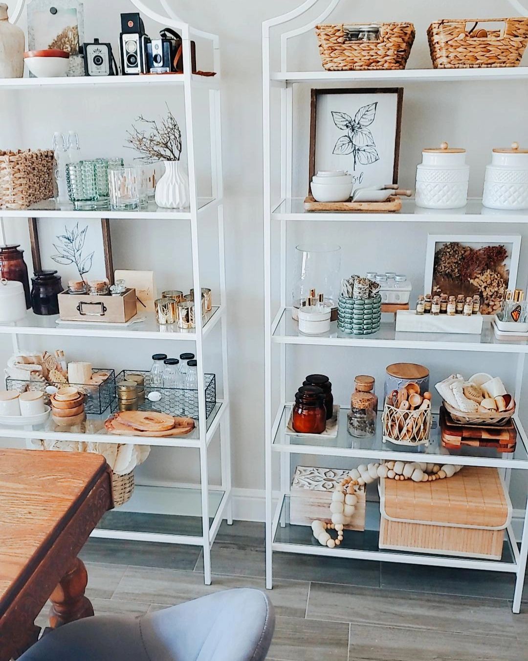 creative studio space with open glass shelves and an antique wood worktop
